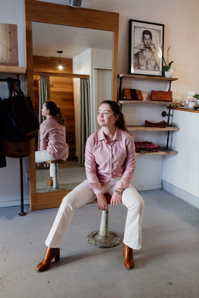 A model sitting on a stool in a clothing shop in Victoria, Canada.