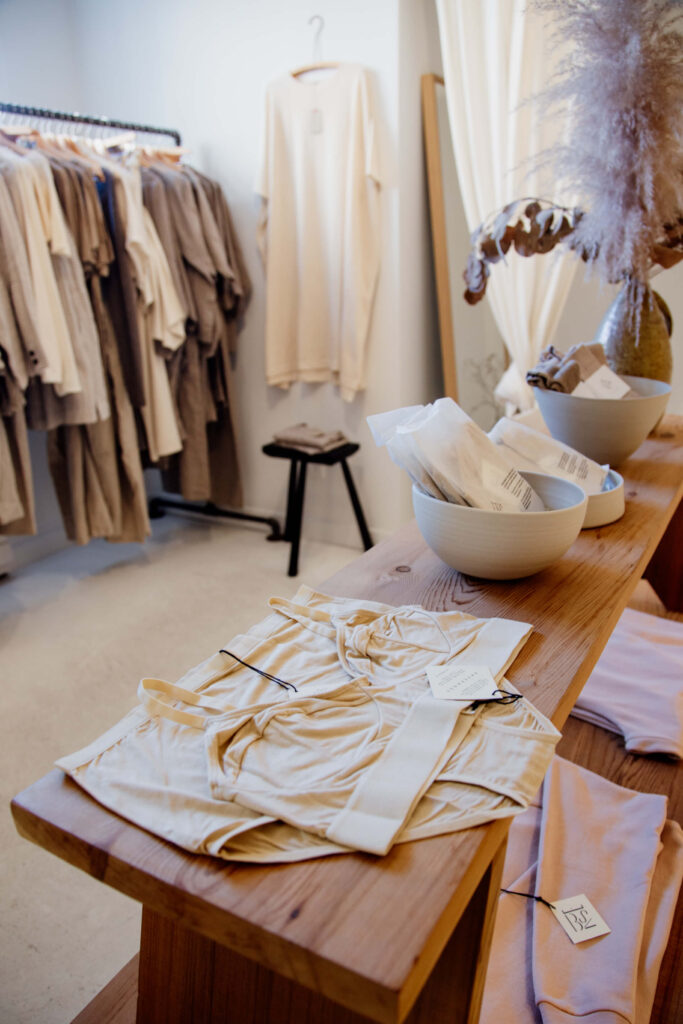 Cotton fashion on a shelf and hanging on a rack.