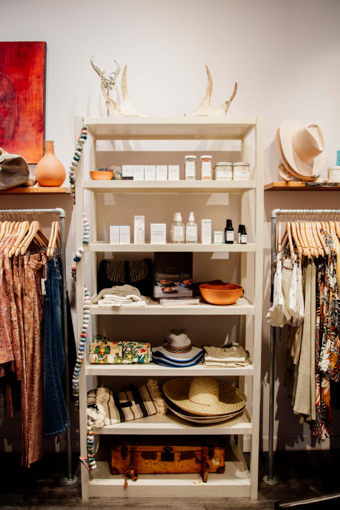 Assorted goods on a shelf in a fashion boutique.