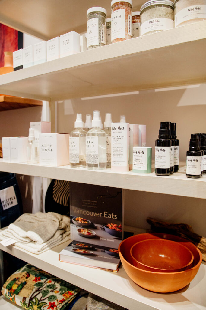 Beauty products and cookbooks on a shelf at the shop.