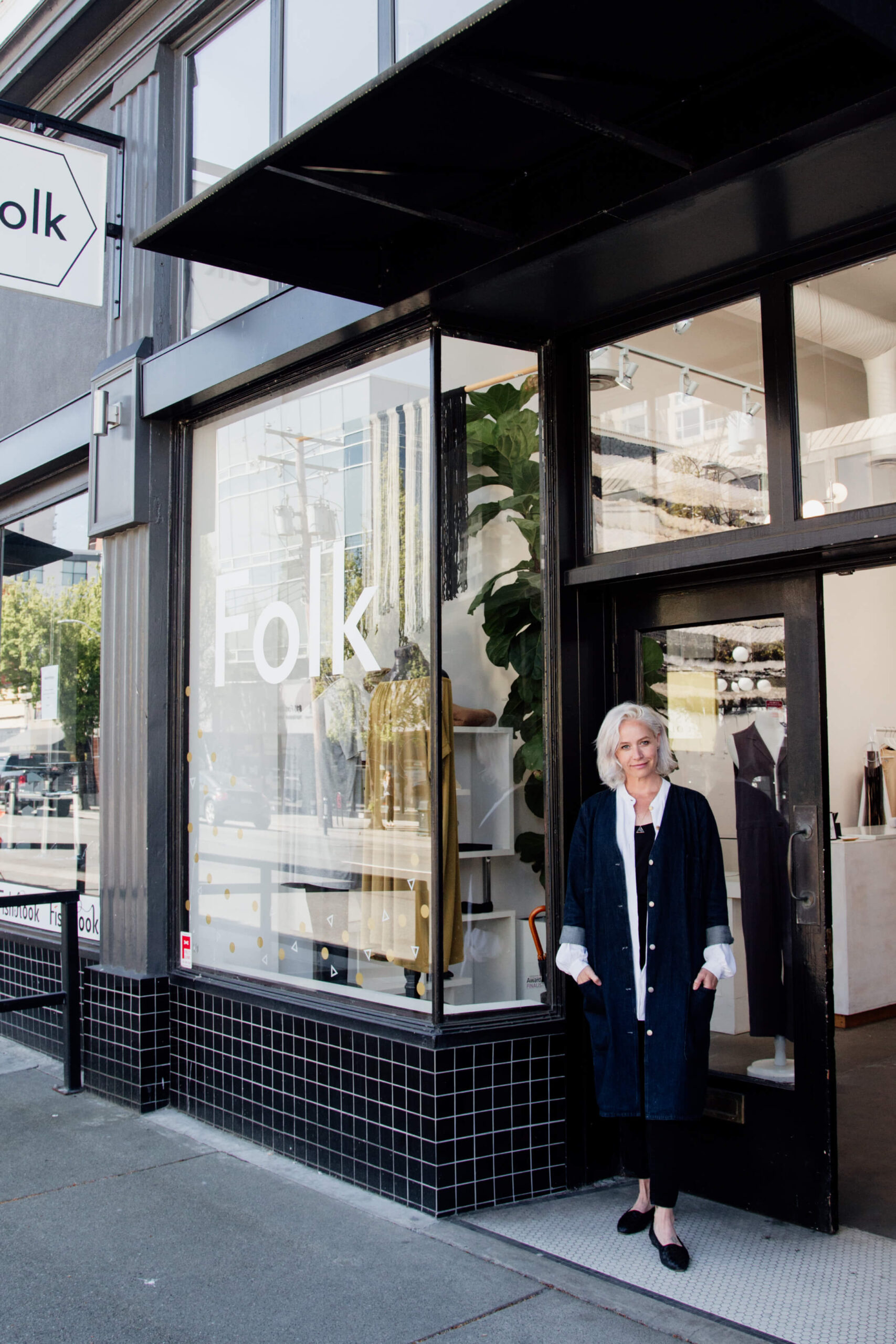 Woman standing outside her shop