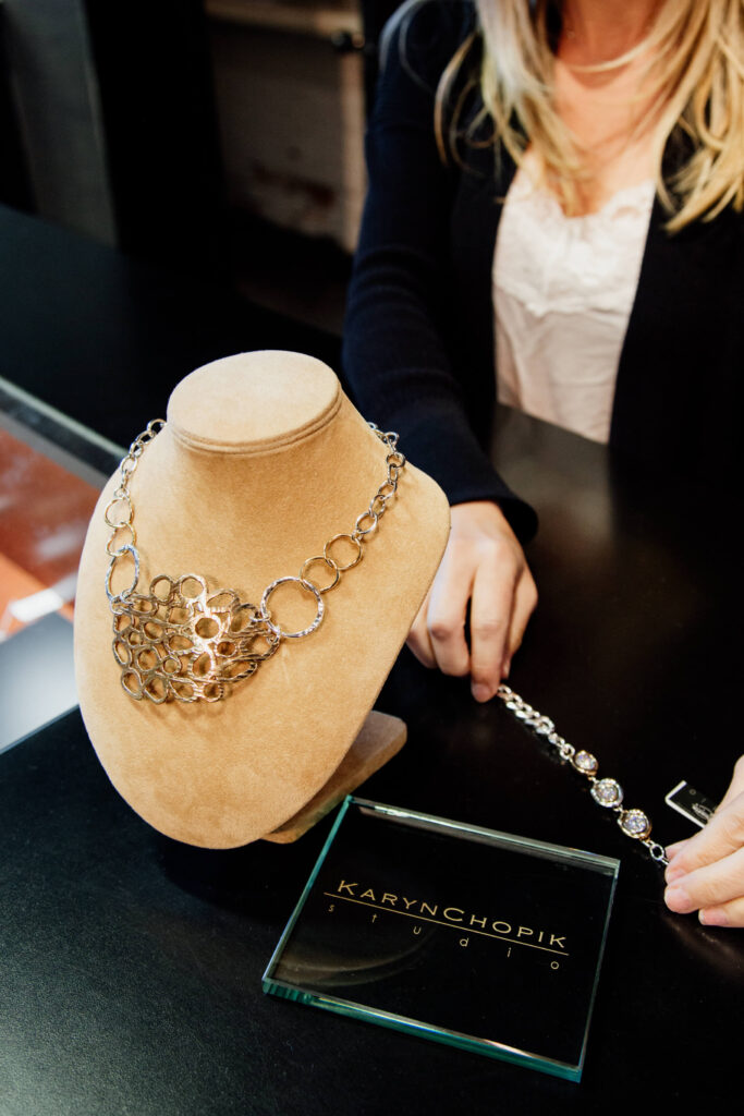 A necklace sits on display at a clothing store.