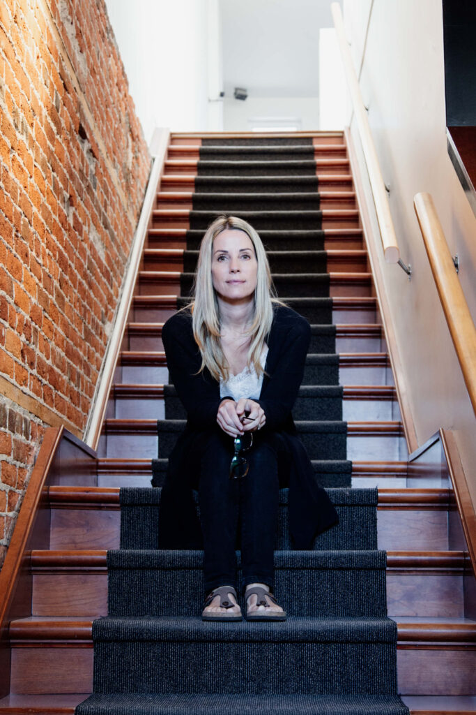 Woman sitting on stairs.