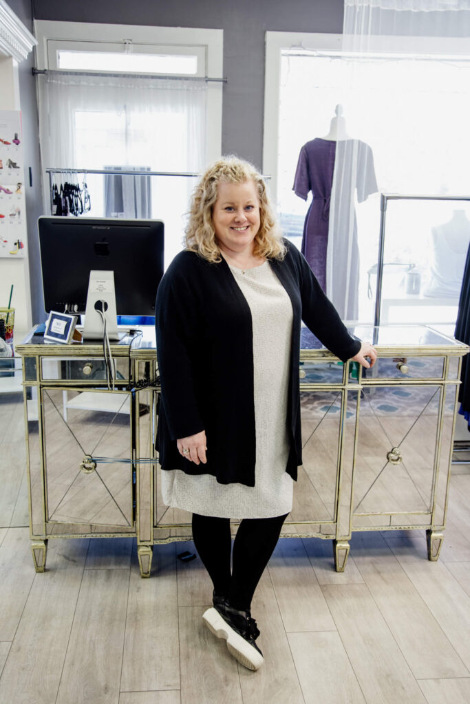 Shop owner standing in front of her desk