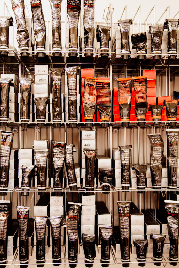 Bottles of hair colour in a shelf at a salon in Victoria, BC.