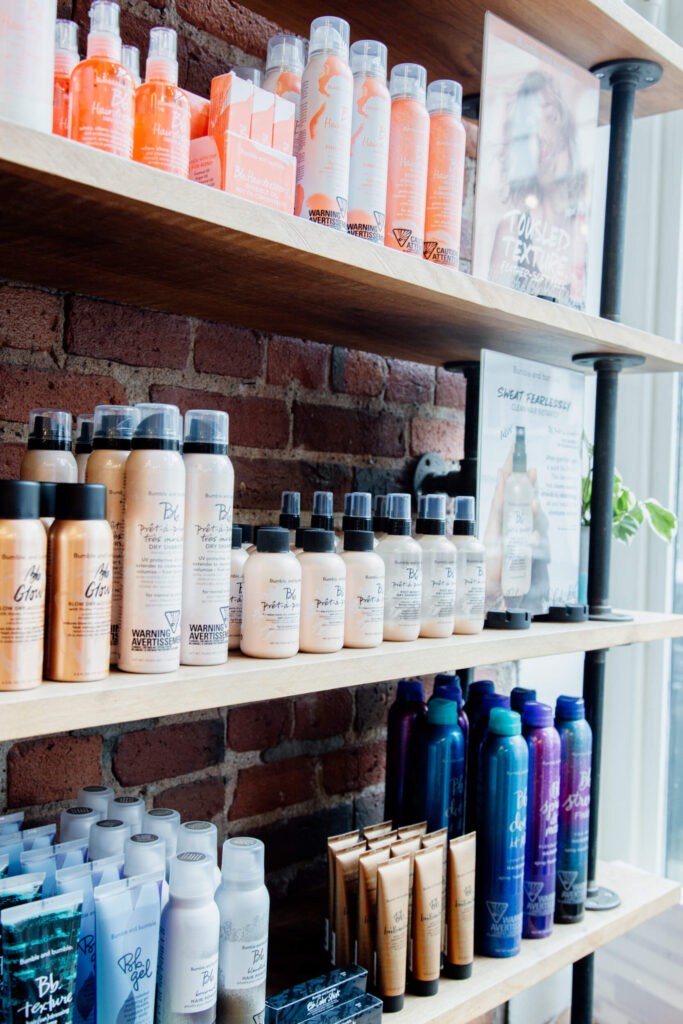 Hair products on a shelf in a salon.