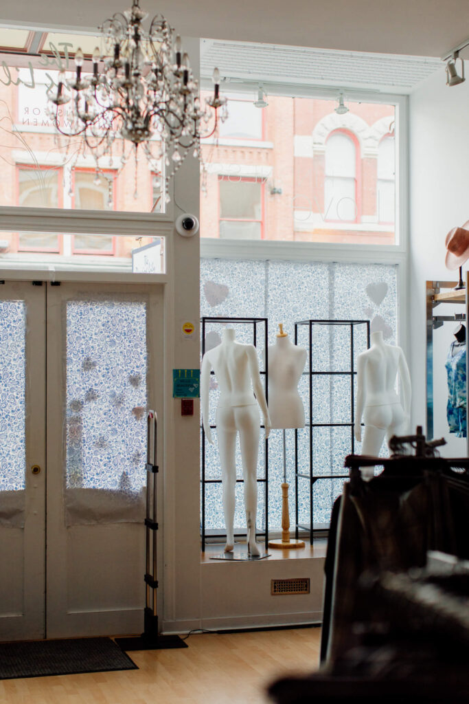 Some undressed mannequins in a shop window.