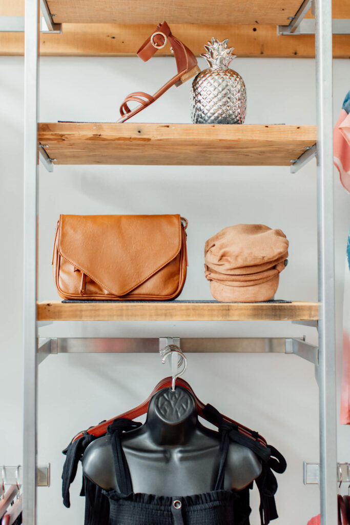 Clothes and bags on the rack in a shop.