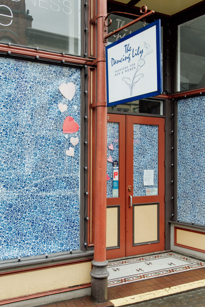 Colourfully papered store windows during the pandemic.