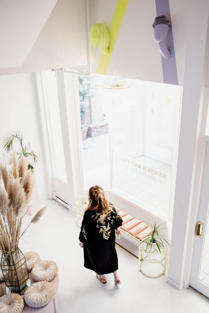 A shop owner walks in her salon.