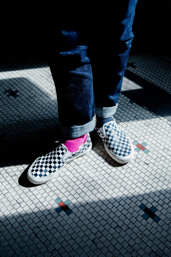 Checkered shoes on a checkered tile floor.