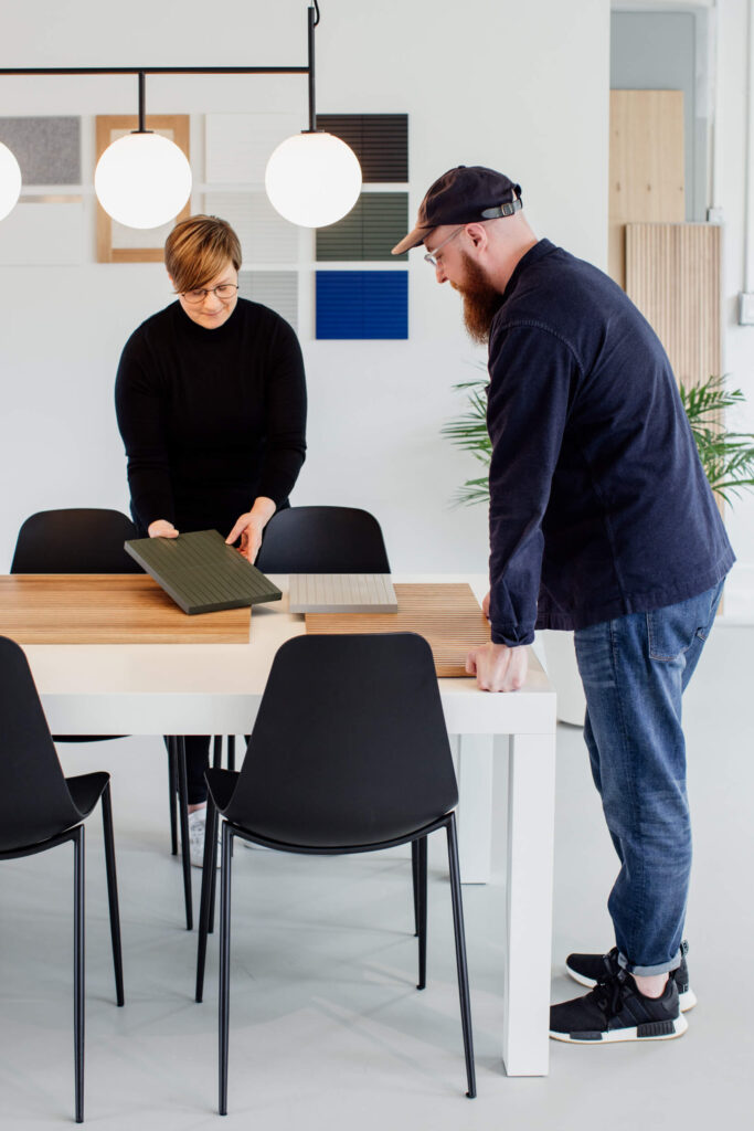 Two designers discuss cabinet doors in a shop in Victoria, BC.