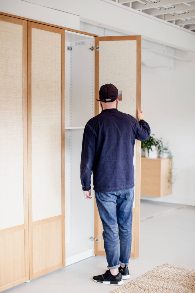 A designer looks in a cabinet in a shop in  Victoria, BC.