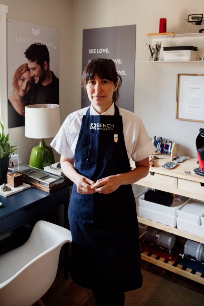 A jeweller poses in her home studio.