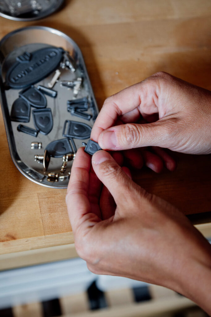 A pair of hands holds some metal jewellry.