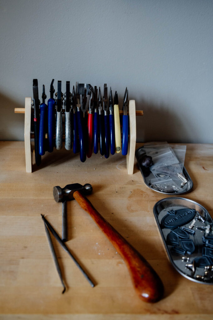 A set of jewellery-making tools on a bench.