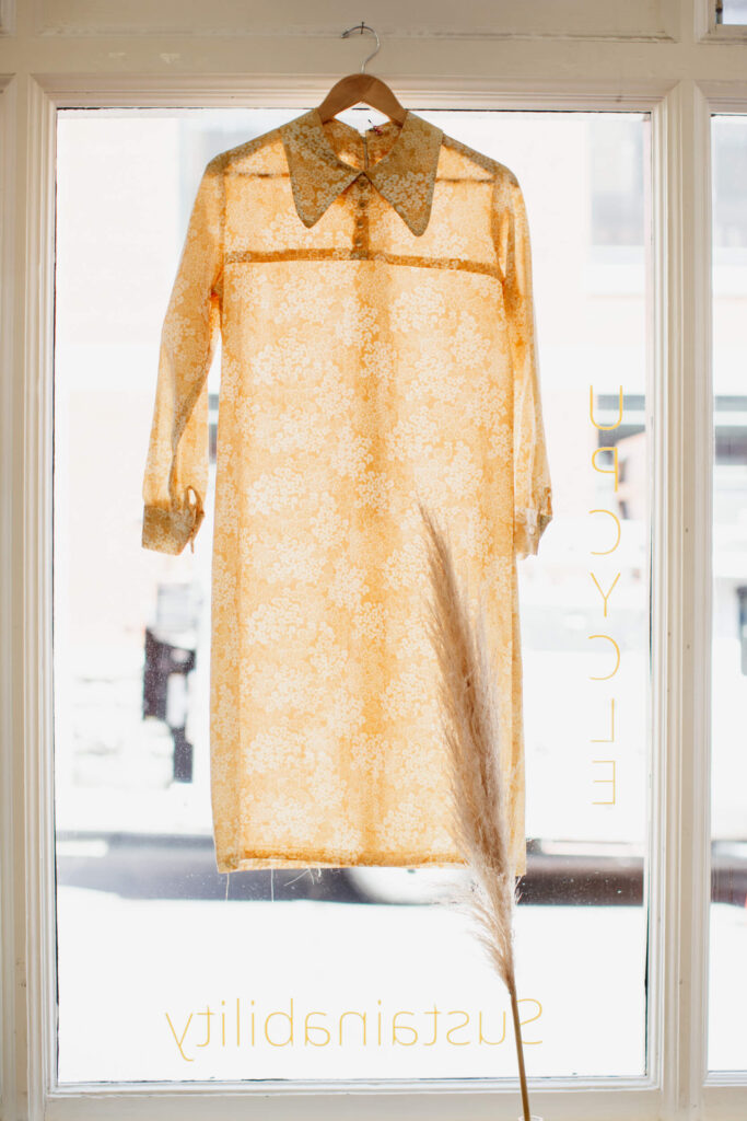 A dress on display in a window in a consignment shop in Victoria, BC.