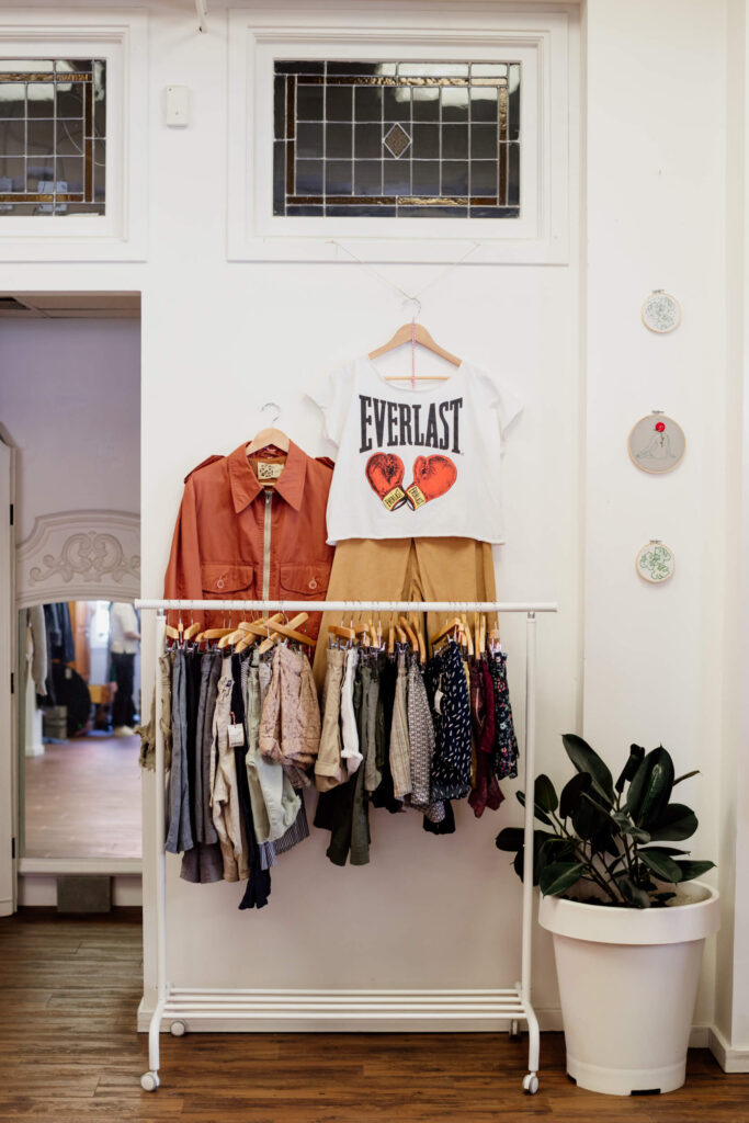 Some shorts and t-shirts on a rack in a consignment shop in Victoria, BC.