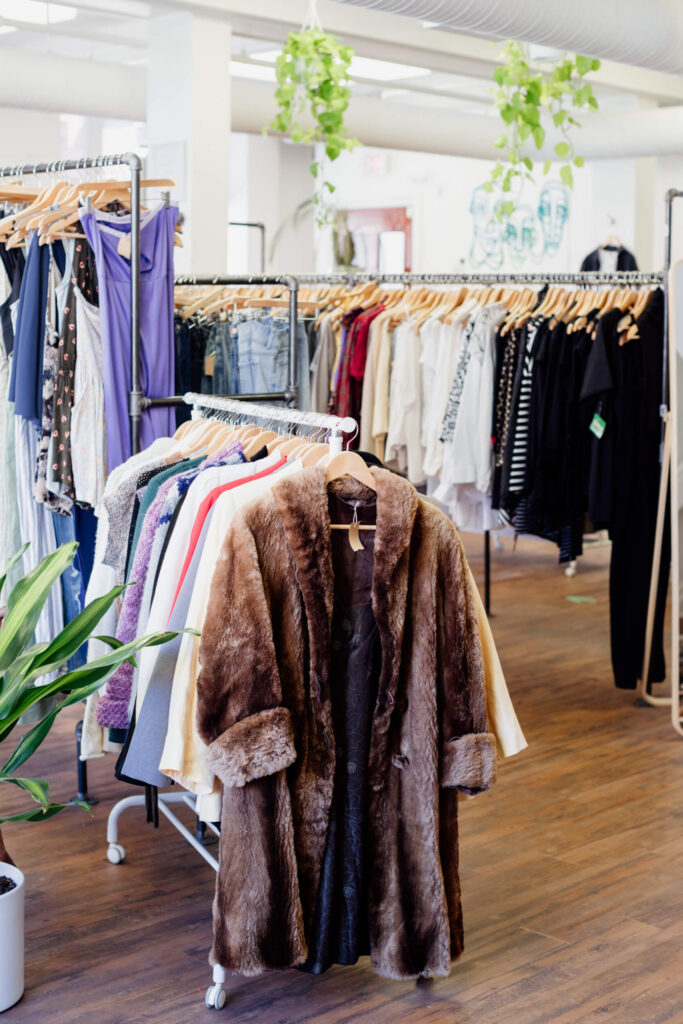 Some coats on a rack in a consignment shop in Victoria, BC.