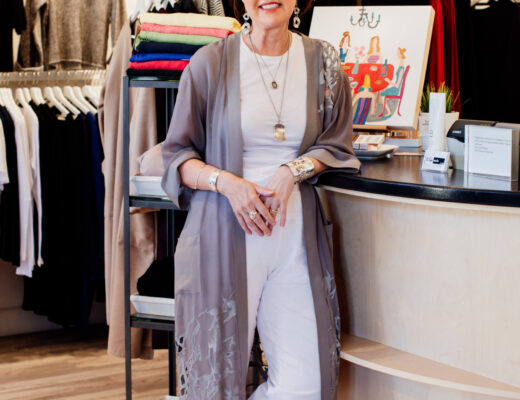 The owner of Tulipe Noire, a clothing store in Victoria, BC, stands inside her shop.