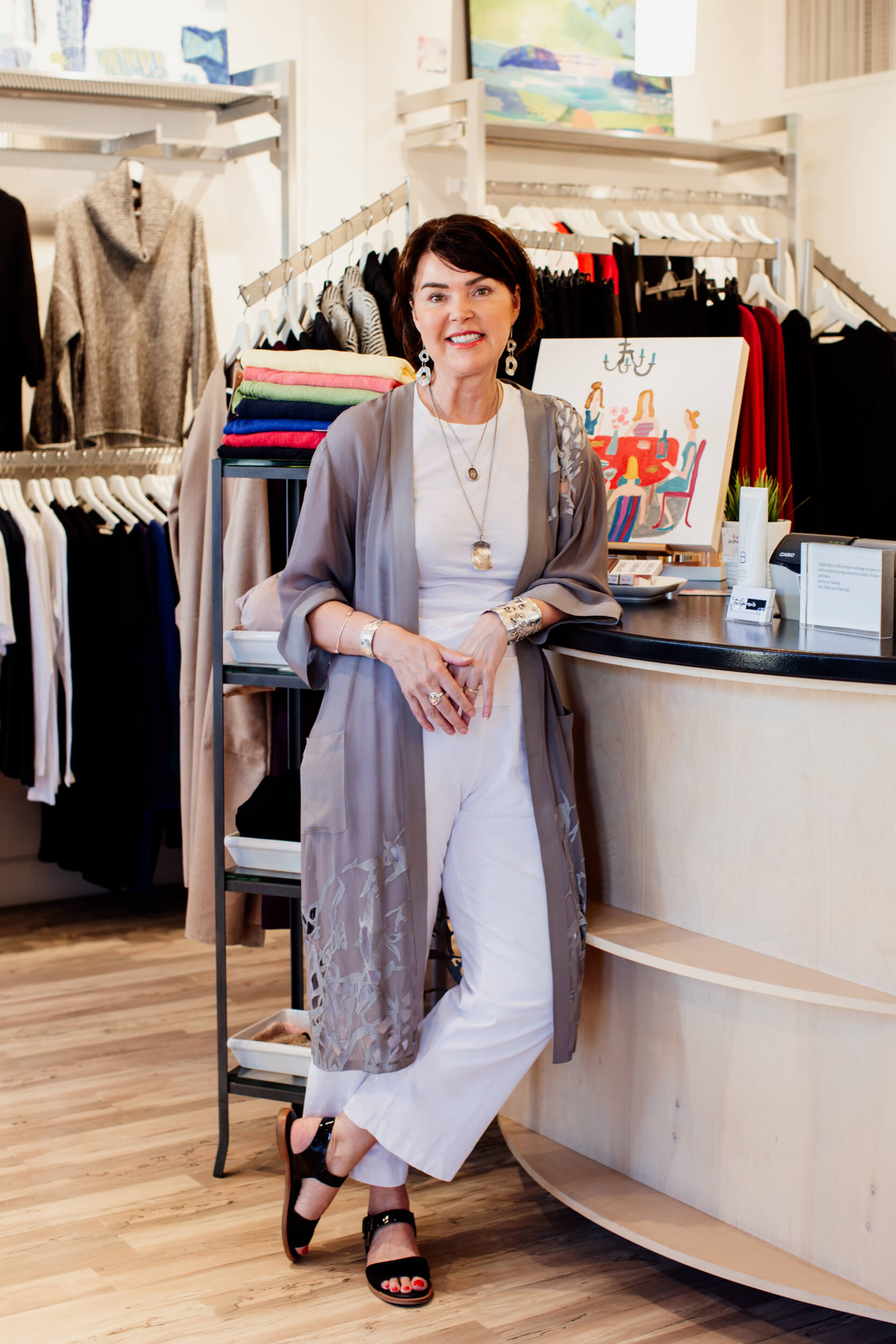 The owner of Tulipe Noire, a clothing store in Victoria, BC, stands inside her shop.