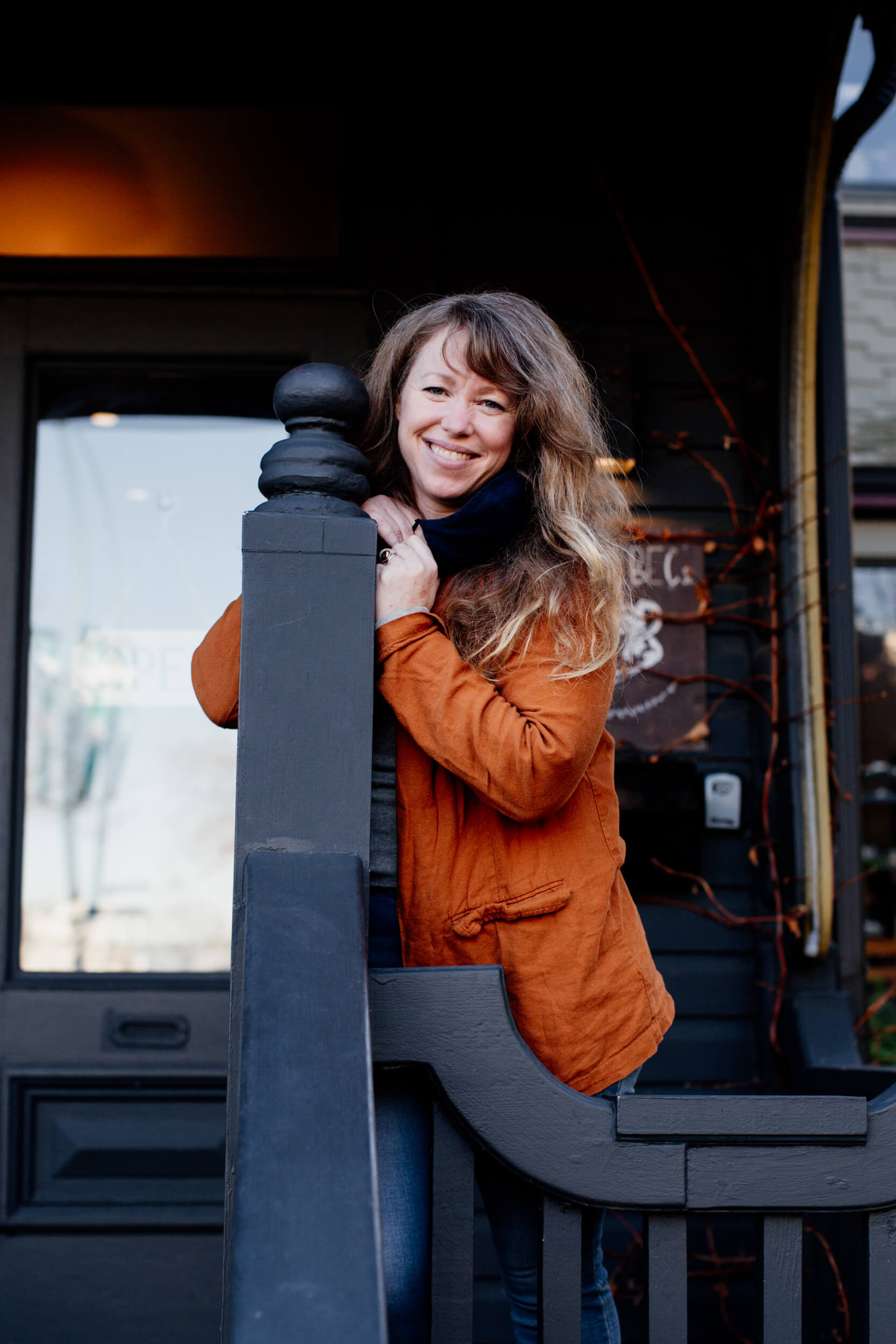 A woman stands outside a cafe in Victoria, BC.