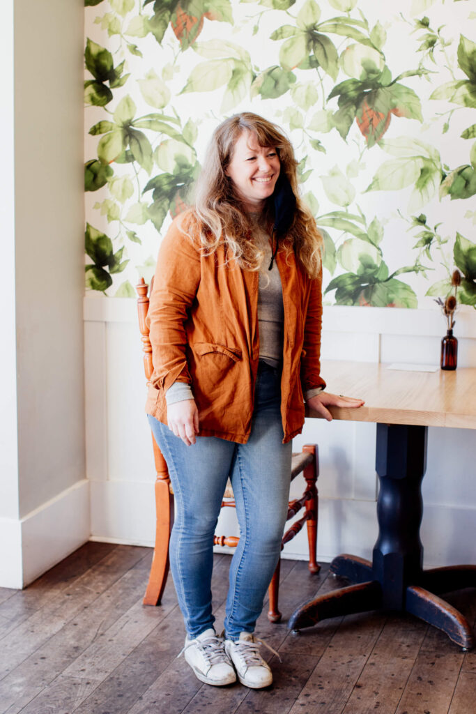 A woman stands inside a cafe in Victoria, BC.