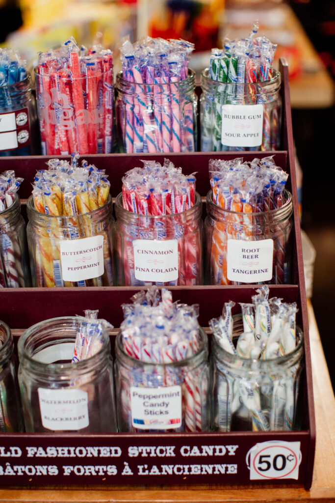 Candy sticks in a jar in a candy store.