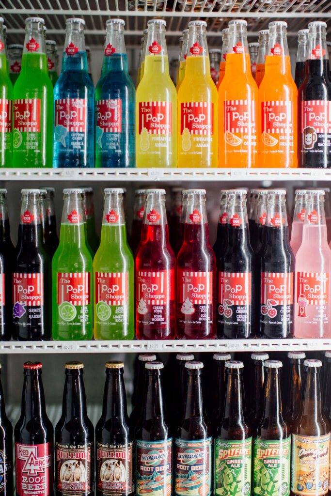 Bottles of Pop Shoppe flavours in a fridge.