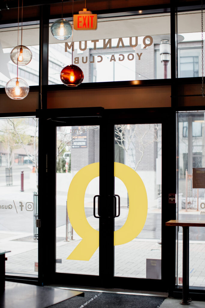 The glass doors of a yoga studio.